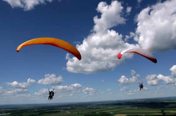 Luxury travelers can try tandem paragliding in Queenstown, New Zealand, which offers a spectacular view of Lake Wakatipu.